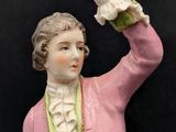 an image of a figurine of a man in a pink suit