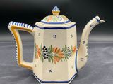 a close up of a teapot on a table with a black background