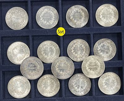 a lot of silver coins in a black box