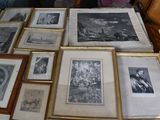 a lot of framed pictures on a table in a room