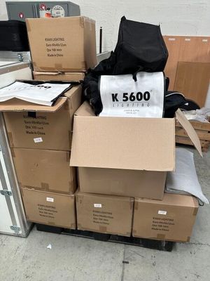 a pile of boxes and a bag sitting on top of it