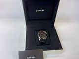 a black watch in a black box with a white tag