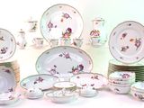 a lot of plates and bowls that are sitting on a table