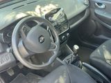 dashboard of a small car with a steering wheel and dashboard controls