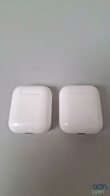 two white apple airpods sitting on top of a white table