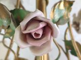 a close up of a rose that is on a gold chandelier