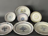 many plates and bowls that are sitting on a table