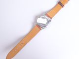 a watch that is sitting on a white surface