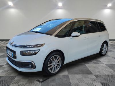 a white citrole is parked in a room with a checkered floor