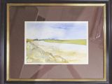framed watercolor painting of a landscape in a brown frame