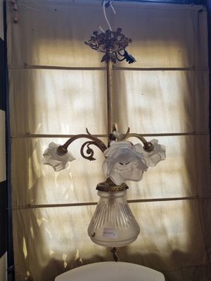 a light that is hanging over a toilet in a bathroom