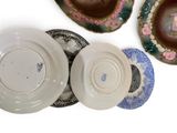 four plates with different designs on them on a white surface