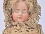 a doll that is wearing a bonnet and a dress