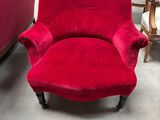 a red chair that is sitting in the middle of a room