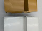 a cardboard box on top of a shelf on the wall