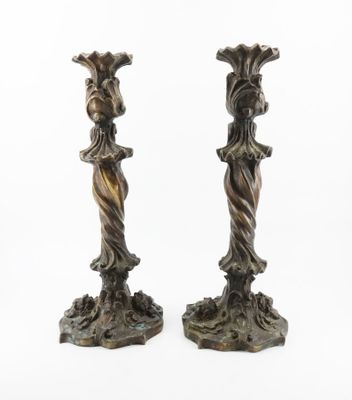 pair of antique bronze candlesticks of a woman and a man