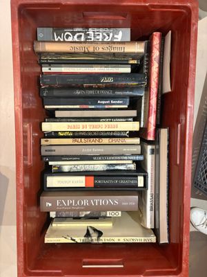 a red box filled with books on top of a table