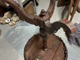 a wooden table with a metal stand on top of it