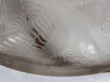 a glass vase with a design on it on a table