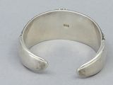 sterling silver cuff bracelet with a single stone in the middle