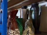 many vases on the shelf in the room