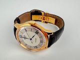 an image of a gold wrist watch with roman numerals on it
