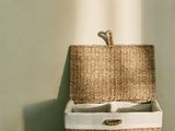 a basket that is sitting on the floor next to a wall