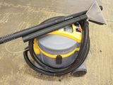 a yellow and black vacuum cleaner on the floor