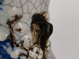 a vase with a blue and white design on it