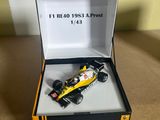 yellow and black model of a racing car in a box