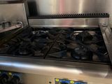 a stainless steel stove top with two burners on it