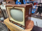 un vieux téléviseur posé sur une table en bois