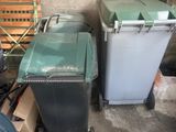 many trash cans and chairs in a room