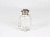 a salt shaker sitting on a white surface