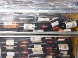 many bottles of wine sitting in a metal case