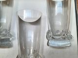 three glass vases sitting in a box on a table