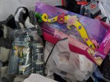a pile of toys and other items on a bed
