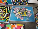 several pieces of art are on the floor in a room