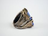 an image of a ring with a blue stone in the middle