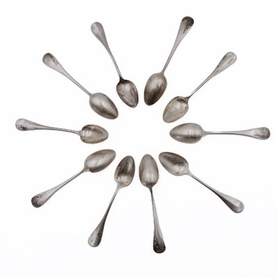 several spoons are arranged in a circle on a white surface