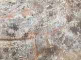 a close up of a rock with a piece of art on it