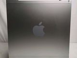 a silver apple computer sitting on a white surface