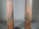pair of antique marble columns on pedestals on grey background