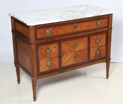a marble top chest of drawers with a marble top