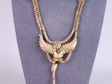a close up of a necklace on a mannequin mannequin