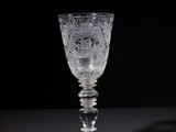 a close up of a glass on a table with a black background