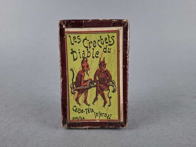 an old matchbox with a picture of two men on horseback