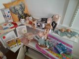 a small table with a doll and other toys on it