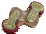 a pair of sandals that are sitting on top of a wooden board