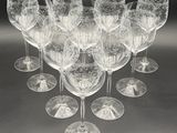 many wine glasses that are lined up on the table